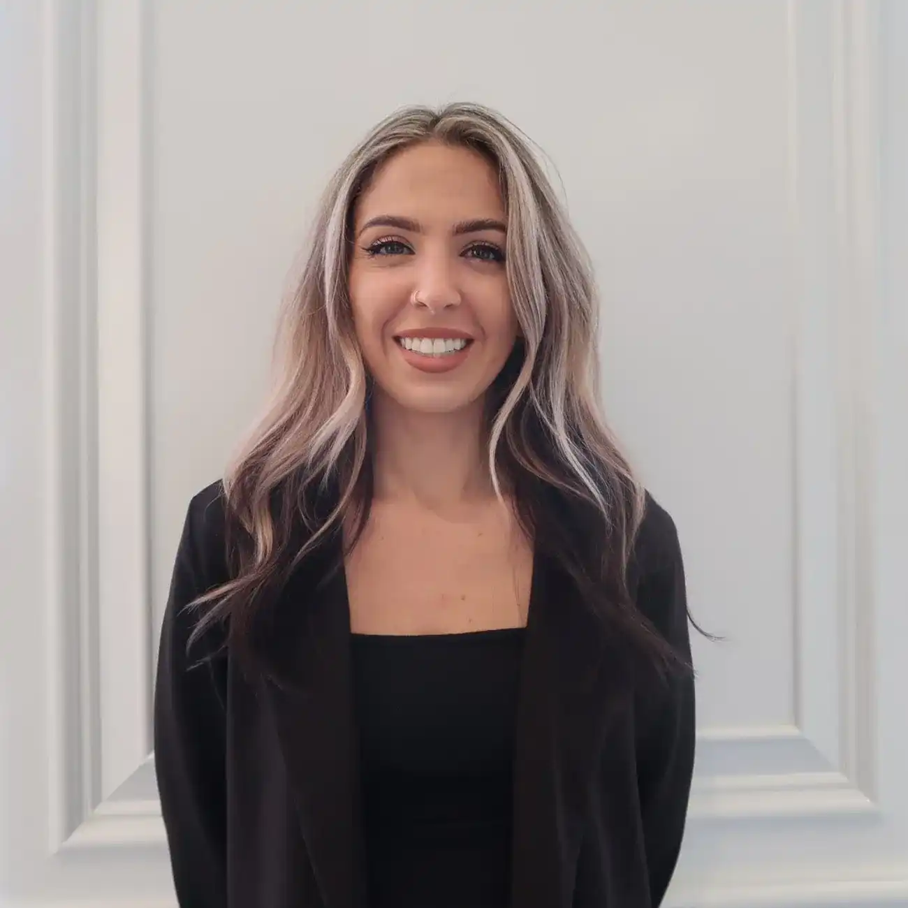 Portrait of Corinne, a professional stylist at Panico Salon & Spa, showcasing their expertise and style.