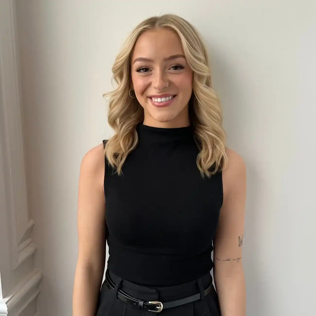 Portrait of Bella, a professional stylist at Panico Salon & Spa, showcasing their expertise and style.